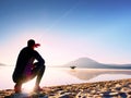 Man exercising on beach. Silhouette of active man exercising and stretching at lake Royalty Free Stock Photo