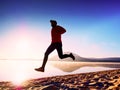 Man exercising on beach. Silhouette of active man exercising and stretching at lake Royalty Free Stock Photo