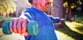 Man exercising with dumbbell on sunny day Royalty Free Stock Photo