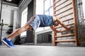 Man exercising on gymnastics wall bars in gym Royalty Free Stock Photo