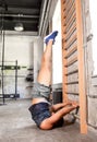 Man exercising at gymnastics wall bars in gym Royalty Free Stock Photo