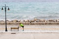 Man exercising and running on city street at seaside