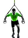 Man exercising suspension training trx silhouette Royalty Free Stock Photo