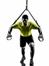 Man exercising suspension training trx silhouette Royalty Free Stock Photo