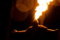 Man exhaling fire on a black background. Fire show