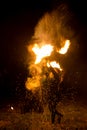 Man exhaling fire on a black background. Fire show