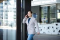 Man exiting building with mobile phone Royalty Free Stock Photo