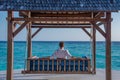 Man in expensive shirt relaxing at the swing  at the tropical island luxury resort Royalty Free Stock Photo