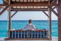 Man in expensive shirt resting at the swing  at the tropical island luxury resort Royalty Free Stock Photo