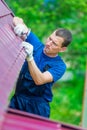 The man is an experienced worker repairing the roof of a residential private house Royalty Free Stock Photo