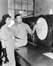 Man explaining about radar to a young woman in a control room Royalty Free Stock Photo