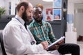 Man explaining symptoms to doctor in consultation Royalty Free Stock Photo