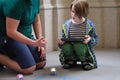 A man explains to a boy the rules of a game with robots