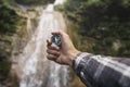 Man Explorer Searching Direction With Compass On Waterfall Background, Point Of View Hiking Journey Travel Trek Concept