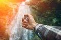 Man Explorer Searching Direction With Compass On Waterfall Background, Point Of View Hiking Journey Travel Trek Concept