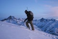 Man explorer with a snowboard behind his back climb on high mountain Royalty Free Stock Photo