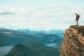 Man explorer standing on cliff alone mountain summit Royalty Free Stock Photo