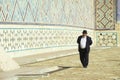 Man explores mausoleum of Khoja Ahmed Yasavi in Turkistan, Kazakhstan.