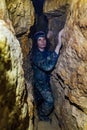 Man explores narrow cave Royalty Free Stock Photo