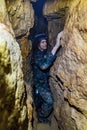 Man explores narrow cave Royalty Free Stock Photo