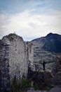 Man exploring ancient ruins citadel in spring time at trascau romania