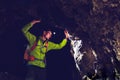 Man exploring underground dark cave tunnel Royalty Free Stock Photo