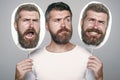 Man expressing different emotions. Feeling and emotions. Hipster with sad face hold portrait nameplate