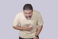 A man expressing great disgust. Pretending to vomit as a gesture of being revolted. Scene isolated on a gray background Royalty Free Stock Photo