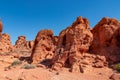 Valley of Fire - Man at exterior entrance of windstone arch (fire cave) in Valley of Fire State Park, Mojave desert, Nevada, USA Royalty Free Stock Photo