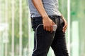 Man with external battery in pocket holding smart phone Royalty Free Stock Photo