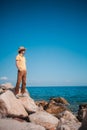 Man exuding style against the sea, relishing the journey amidst coastal tranquility