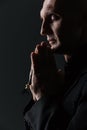 Man with eyes closed holding rosary and praying Royalty Free Stock Photo