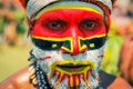 Man with face in colours in Papua New Guinea