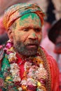Man with face fully smeared with colours