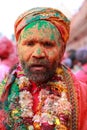 Man with face fully smeared with colours