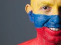 Man face painted with colombian flag, smiling expression Royalty Free Stock Photo