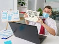 Man in face mask shows Business continuity plan while online meeting.