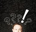 Man face with question mark on blackboard science background. Education, student exam and brainstorm concept Royalty Free Stock Photo