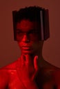 man, face and red light with futuristic glasses for edgy cyberpunk fashion, modern gen z fantasy and sci fi model for