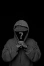 man faceless hoodie and hat  black white studio photo. concept of mystery man, criminal, robber, hacker Royalty Free Stock Photo