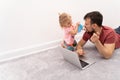 Man in facial protective mask and his daughter tries to put off it from his face