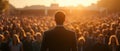 Man facing crowd at sunset: leadership and public speaking Royalty Free Stock Photo