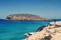 Man facing the Illa des Bosc island, in Ibiza, Spain