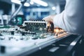 A man in a factory assembles and tests an electronic board. Modern production of electronic components Royalty Free Stock Photo