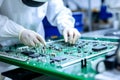 A man in a factory assembles and tests an electronic board. Modern production of electronic components Royalty Free Stock Photo