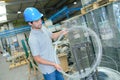 Man in factory holding roll wire