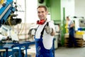 Man in factory with thumb up