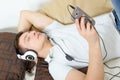 Man fall asleep listening to music over smartphone with headphones Royalty Free Stock Photo