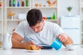 Man falling asleep during his breakfast after overtime work Royalty Free Stock Photo