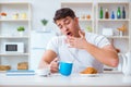 The man falling asleep during his breakfast after overtime work Royalty Free Stock Photo